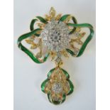 A delightful enamelled and white stone encrusted brooch of floral form.