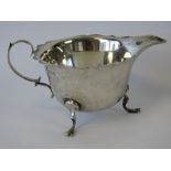 A HM silver jug with pie crust rim, raised over three outswept feet, 2.21ozt.