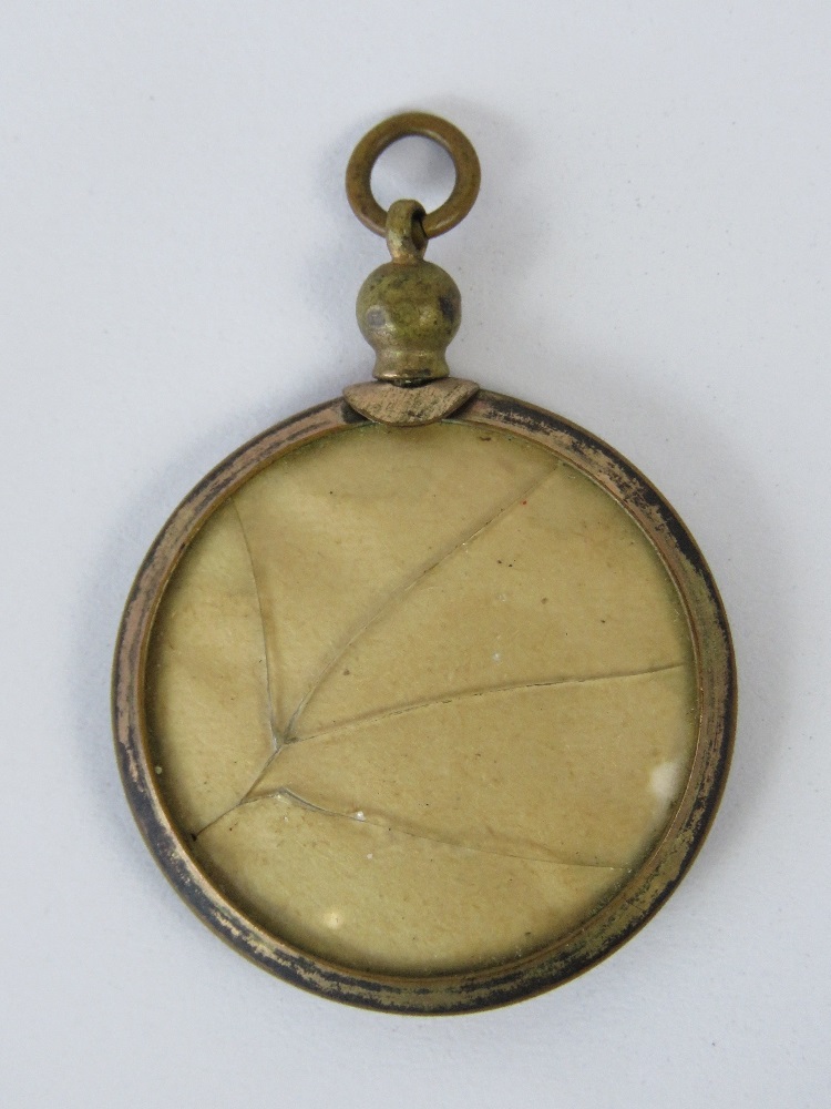 A rolled gold locket containing a photo of a man in uniform. - Image 2 of 2