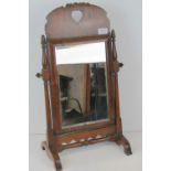 A delightful walnut Welsh toilet mirror having bevel edged square shaped glass and raised over H