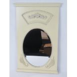 A contemporary cream painted bevel edge framed oval mirror, 68 x 43cm.