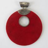A silver geometric pendant, red circular