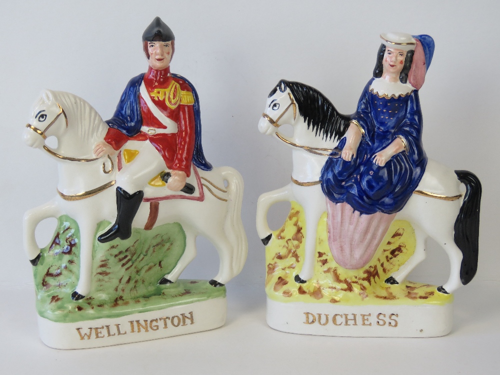 A pair of Staffordshire figurines on hor