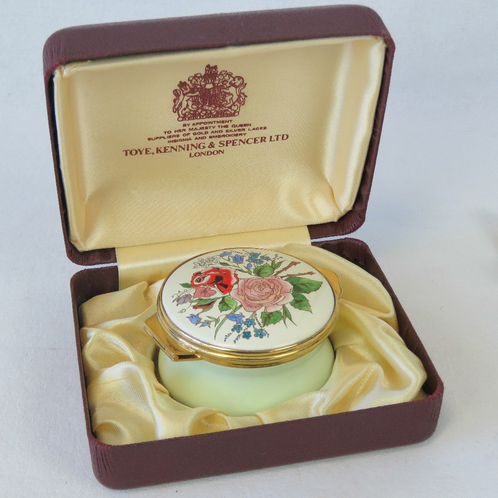 A circular enamelled box, the hinged lid