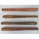 Four vintage turned wood truncheons.