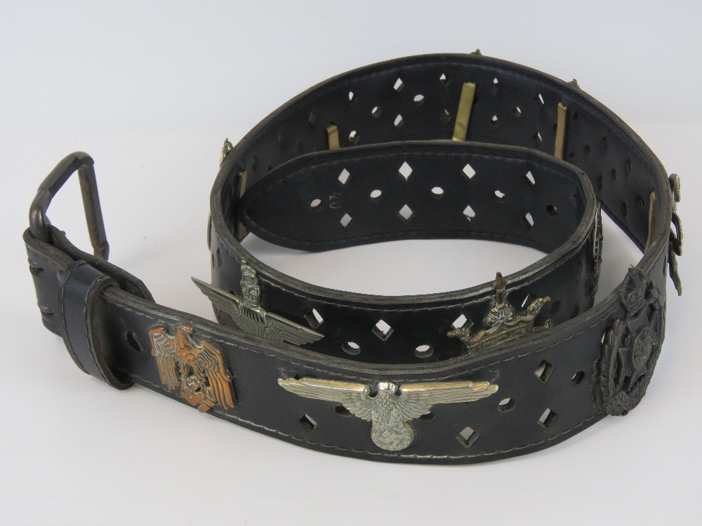 A black leather belt with applied milita