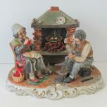 A Capodimonte porcelain figure group entitled 'The Old Folk' and of a couple seated by a fire,