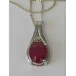 A silver and ruby pendant of teardrop form, large oval cut ruby surmounted by trio of white stones,