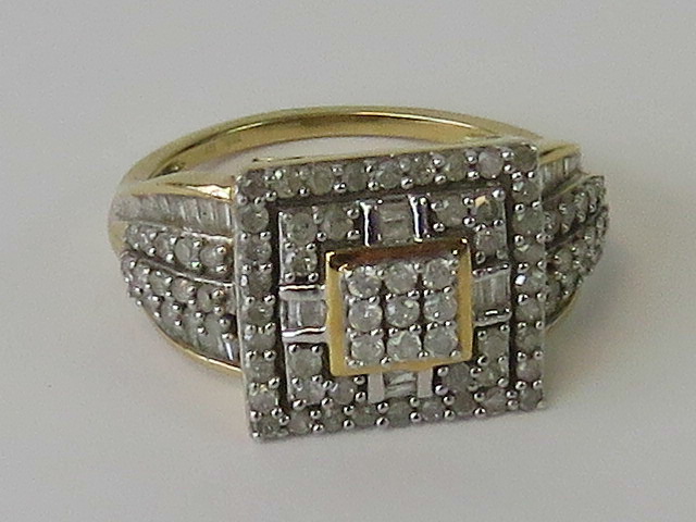 A silver cocktail ring, three square shaped tiers encrusted with white stones,