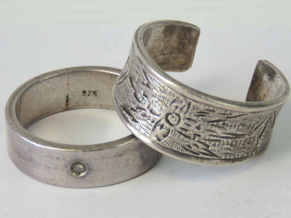 A silver ring with engraved floral pattern, approx size S, stamped Stirling,