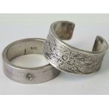 A silver ring with engraved floral pattern, approx size S, stamped Stirling,