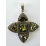 A 925 silver pendant set with five green amber cabachons, 3.5cm including bale.