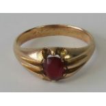 A rose metal ring set with oval red stone, 4.8g.