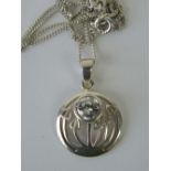 A silver Rennie Mackintosh style floral pendant set with round cut white stone, 2.