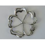 A silver pendant in the form of a five petalled flower, double bale to back, stamped 925, 5.5cm dia.