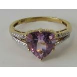 A silver cocktail ring, large central triangular cut lilac stone, gold plated on silver stamped 925,