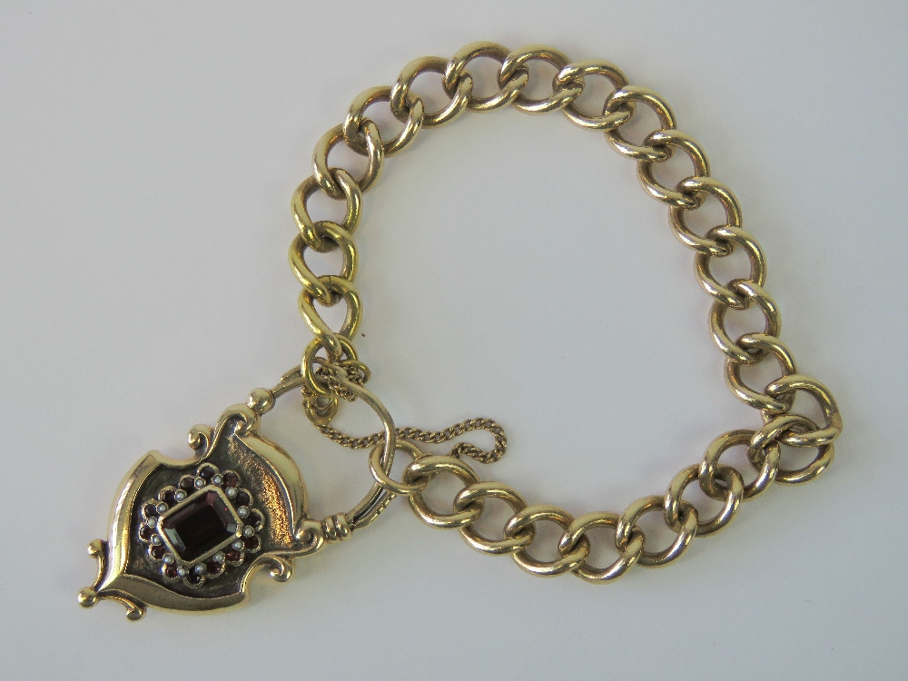 A 9ct gold heavy curb link bracelet with large padlock clasp,