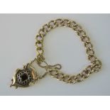 A 9ct gold heavy curb link bracelet with large padlock clasp,