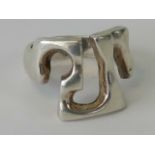 An abstract design silver ring, stamped 925, size N.