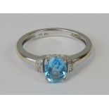 A 9ct white gold topaz and diamond ring,