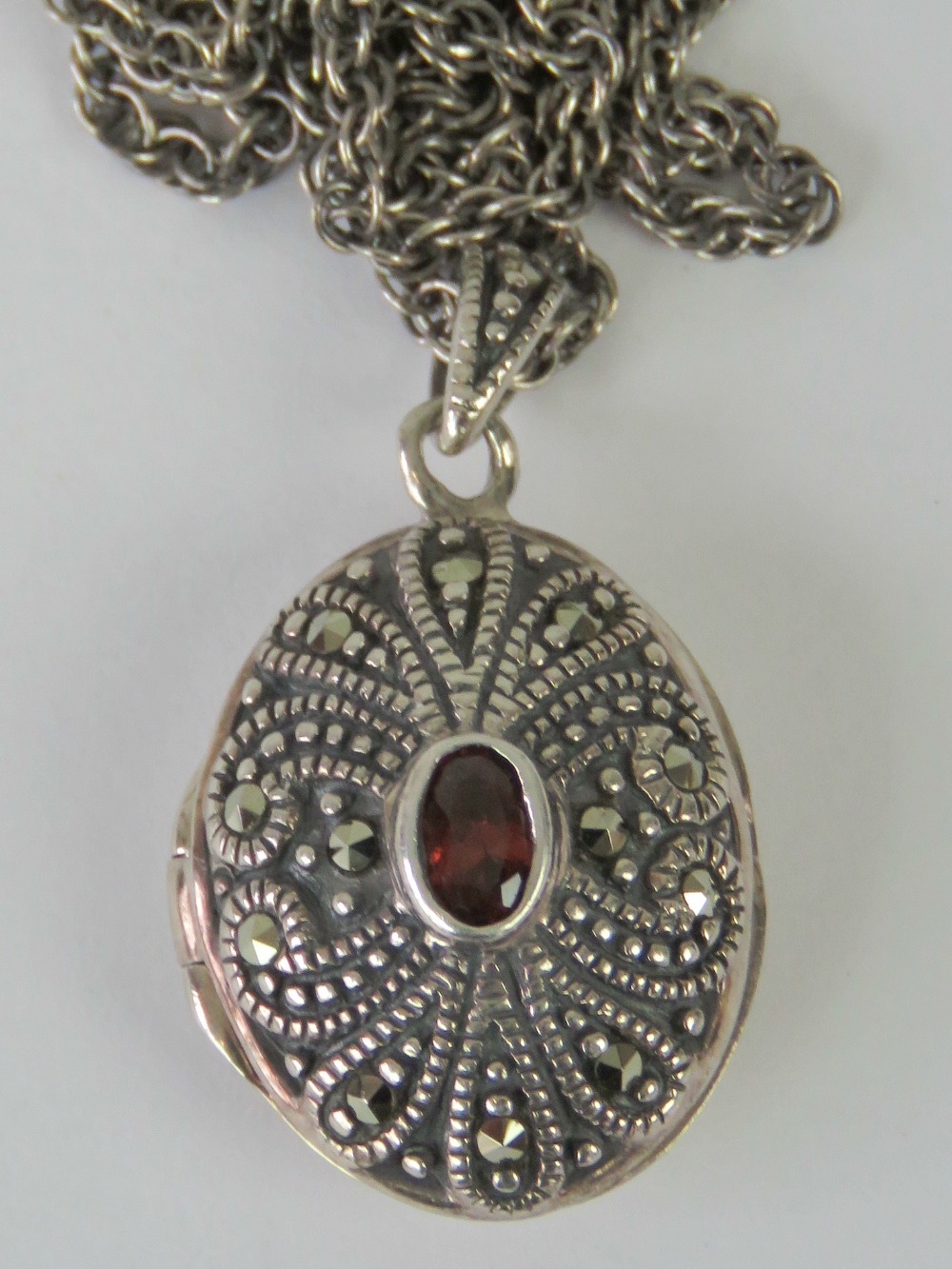 A 925 silver and marcasite locket, compl