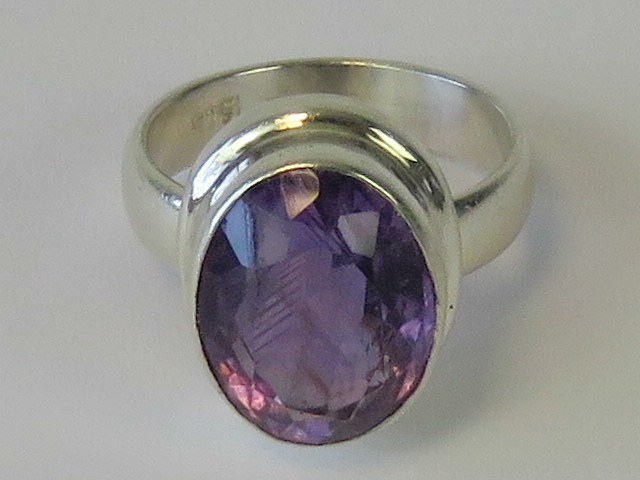 A silver ring set with large oval cut am