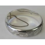 A HM silver bangle with engraved leaf pa