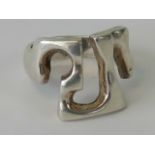 An abstract design silver ring, stamped