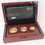 A 22ct gold three coin proof 2015 set comprising £50, £25 and £10 coins, total weight 28.