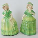 A pair of heavy ceramic crinoline lady figurines, each for use as a doorstop, 20cm high.