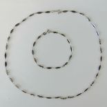 A silver necklace and bracelet set, each with alternating oval and twisted links, necklace 46cm,
