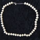 A string of large white/pink baroque pearls,