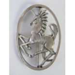 A George Tarratt HM silver brooch designed by Geoffrey Bellamy and depicting a prancing unicorn