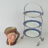 A 1930s three tier cake stand together with a Royal Doulton character jug 'Arry'. Two items.