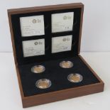 A 22ct gold set of four proof 2010-2011 £1 coins; 'London', 'Belfast', 'Edinburgh', and 'Cardiff',