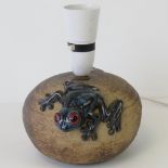 A John Milner lamp base with 3D blue poison dart frog design, wired for electricity, 14cm dia.