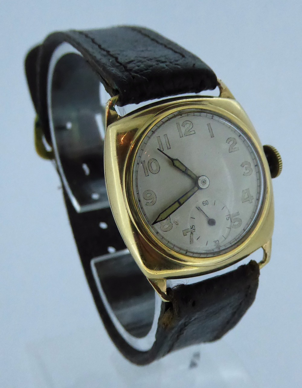 A 9ct gold cushion cased gents 1945 presentation watch, inscribed to reverse. Total weight 26g.