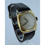 A 9ct gold cushion cased gents 1945 presentation watch, inscribed to reverse. Total weight 26g.