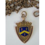 A 9ct rose gold enamelled fob engraved for Wellingborough Charity Cup 1925, as retailed by C.