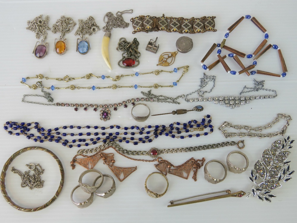 A quantity of assorted costume jewellery including white metal rings, copper and brass bangle,