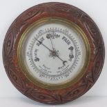 A barometer with silvered dial and brass case,