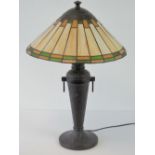 A modern Tiffany style table lamp with conical leaded light glass shade and slender beaten bronze