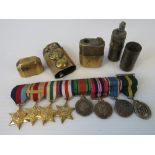 A WWII Players Medium Navy Cut cigarette tin containing a set of eight miniature medals on bar,