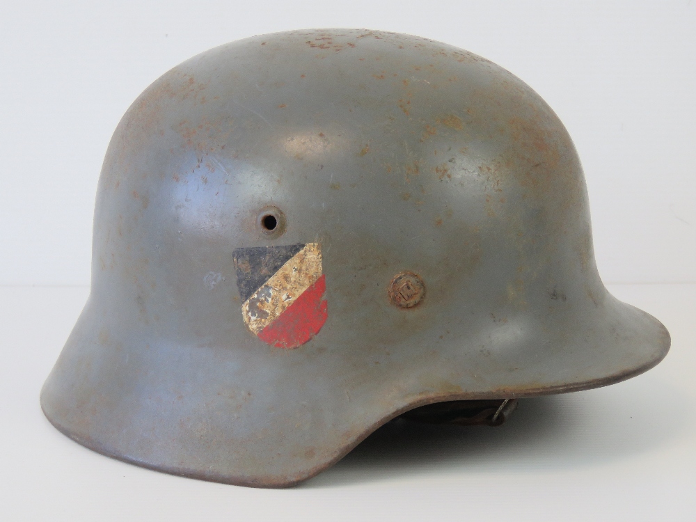 A WWII German helmet with double decal, handwritten name within, replacement liner and chin strap, - Image 2 of 4