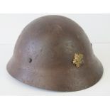 A WWII Japanese Civil Defence helmet with painted name and detachment details within,