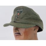 A WWII German Army ski cap with eagle, dated 1943.