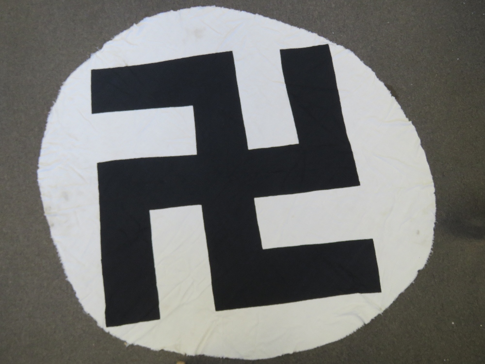 A WWII German Swastika flag centre having been taken as a souvenir by a veteran, approx 157cm wide.