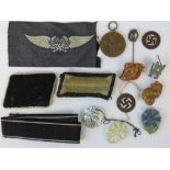 A mixed lot of German badges including; War Merit medal, four WHW badges, four cloth badges,