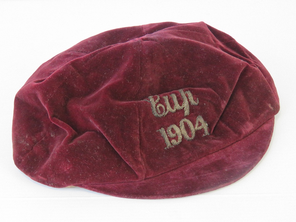 An Edwardian red velvet sports cap with