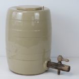 A stoneware keg with loose lid and tap,